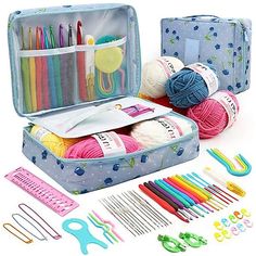 an open suitcase filled with knitting supplies and crochet hooks