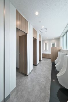 an empty public restroom with urinals and sinks