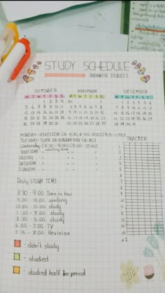 a student's study schedule is shown on top of a desk with pens and pencils