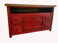 an old red cabinet with drawers and doors on it's sides, against a white background