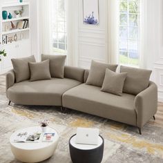 a living room filled with furniture and windows