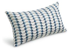 a blue and white pillow on a white background