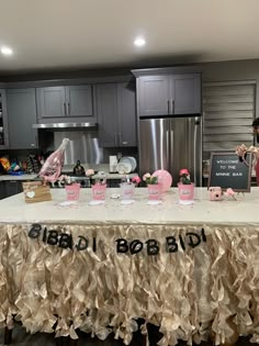 the table is set up with pink and black decorations for a bridal birthday party