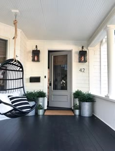 a black and white porch with a hanging chair