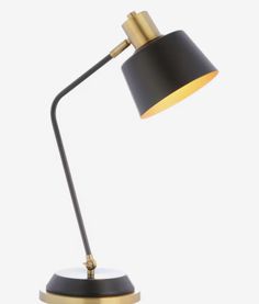 a black and gold desk lamp on a white background, with the light turned off