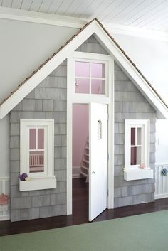 an instagramted photo of a doll house with stairs and windows on the roof