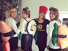 four women dressed up in costumes posing for the camera