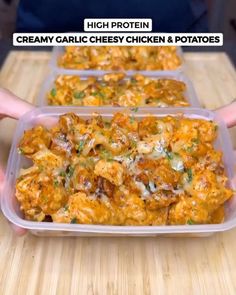 two plastic containers filled with cheesy chicken and potatoes on top of a wooden table