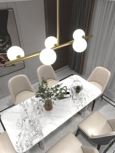 a dining room table with chairs and a vase on it in front of a mirror