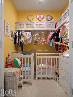 a baby's room with yellow walls and white furniture