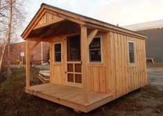 a small wooden cabin sitting on top of a field