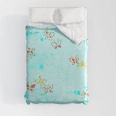 a blue bed with butterflies on it and white sheets in front of the headboard