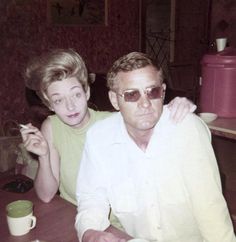 an older man and young woman sitting at a table