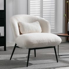 a white chair sitting on top of a carpeted floor