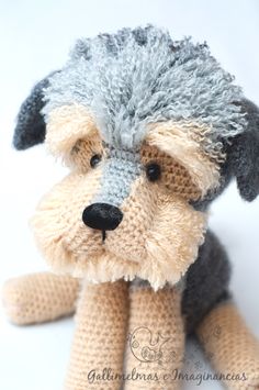 a crocheted stuffed dog is shown in a circular frame with a white background