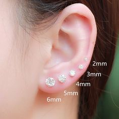 three different types of ear piercings on a woman's ear, with measurements