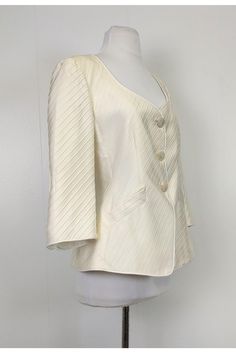 Luxurious blazer in a textured fabric with mother of pearl buttons. Perfect for any dinner party, it can be paired with a fitted skirt and chic flats. Size 10 (IT 46) 84% Silk, 16% nylon Made in Italy Button down front Mother of pearl buttons 3/4 sleeves Textured fabric V-neck Lined Mock front pockets Padded shoulders Bust 39.5" Waist 33.5" Shoulder to hem 24" Chic Single-button Silk Blazer, Summer Formal Blazer With Button Closure, Classic Spring Party Blazer, Elegant Summer Blazer With Buttons, Chic Silk Blazer For Wedding, Designer Structured Blazer For Spring, Designer Spring Blazer With Button Closure, Designer Spring Formal Blazer, Designer Spring Blazer For Formal Occasions