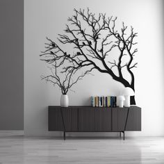 a black and white photo of a tree on a wall