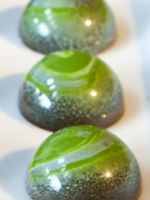 three green marbles sitting on top of each other