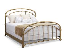 a bed with gold metal frame and pillows