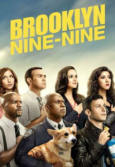 the cast of brooklyn nine - nine standing in front of a cloudy sky, with one man holding a dog