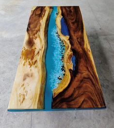 a wooden table with blue water in the center and brown wood grain on it's edges