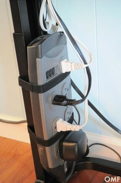 an electronic device is plugged into the wall with wires attached to it and connected to a charger