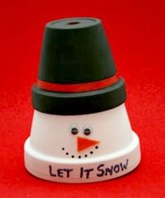 a white and black snowman hat with the words let it snow on it