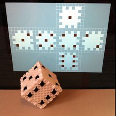 a white and black object sitting on top of a table next to a computer screen