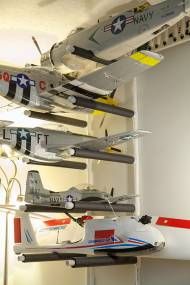 several model airplanes are hanging from the ceiling