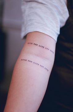 a person with a tattoo on their arm that says live the same life you love