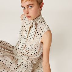 Straight fit Scarf collar Teardrop opening with button on the back Sleeveless Embroidered logo Miu Miu Collared Tops For Work, Luxury Miu Miu Tops For Work, Casual Collared Tops By Miu Miu, Miu Miu White Shirt, Polka Dot Skirt Outfit, Miu Miu Collared Cotton Tops, Dot Skirt Outfit, Blouse Sleeveless, Polka Dot