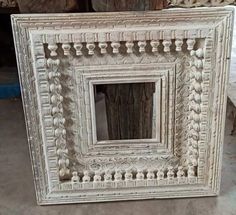 an old white frame sitting on the ground