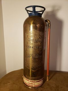 an old fashioned fire extinguisher sitting on a table