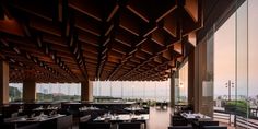 an empty restaurant with large windows overlooking the ocean