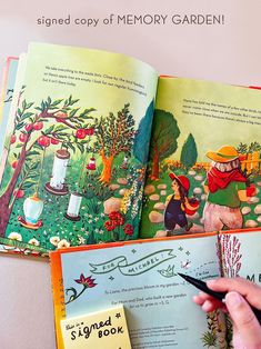 an open children's book with the title signed copy of memory garden