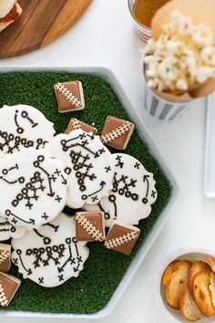 decorated cookies and snacks are on a tray