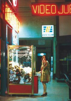 a woman standing in front of a vending machine