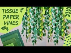 tissue paper vines are hanging on the wall next to a green frame and some pictures