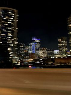 the city skyline is lit up at night