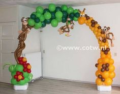 an arch made out of balloons with monkeys on it