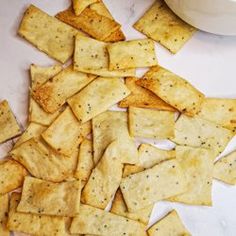 some crackers are sitting on a table next to a bowl