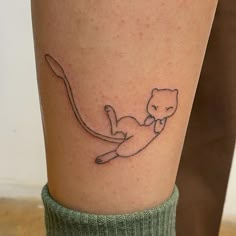 a small cat tattoo on the leg