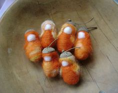 small orange and white wooled objects in a wooden bowl