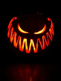 a carved pumpkin with an evil face on it