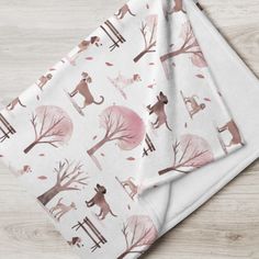 three napkins with cats on them sitting on top of a wooden table next to each other