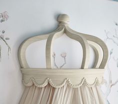 a bed with a canopy and flowers on the wall