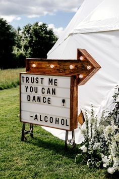 a sign that says trust me you can dance alcohol on the side of a tent