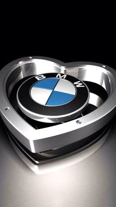 a heart shaped emblem on the front of a bmw car, in silver and black