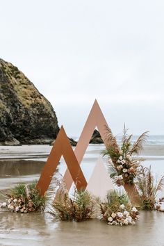 a couple of large metal sculptures sitting on top of a beach